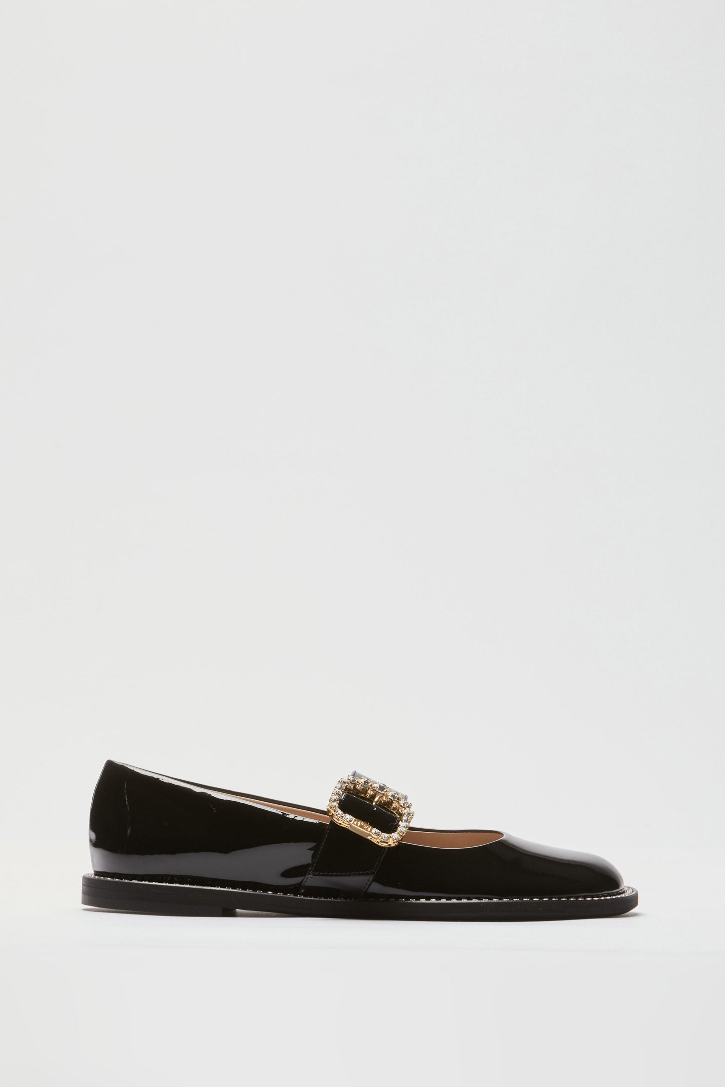 Women's brown leather loafers with gold buckle