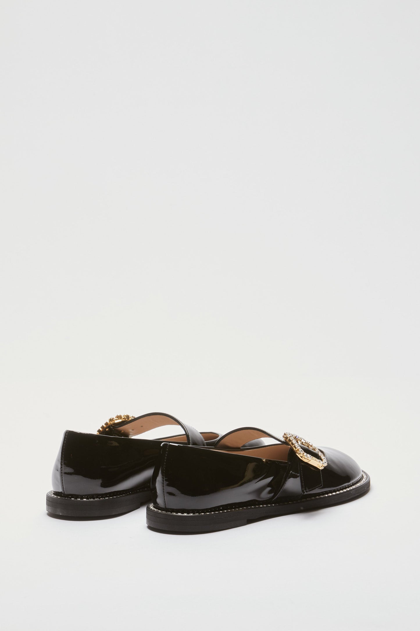 Women's brown leather loafers with gold buckle