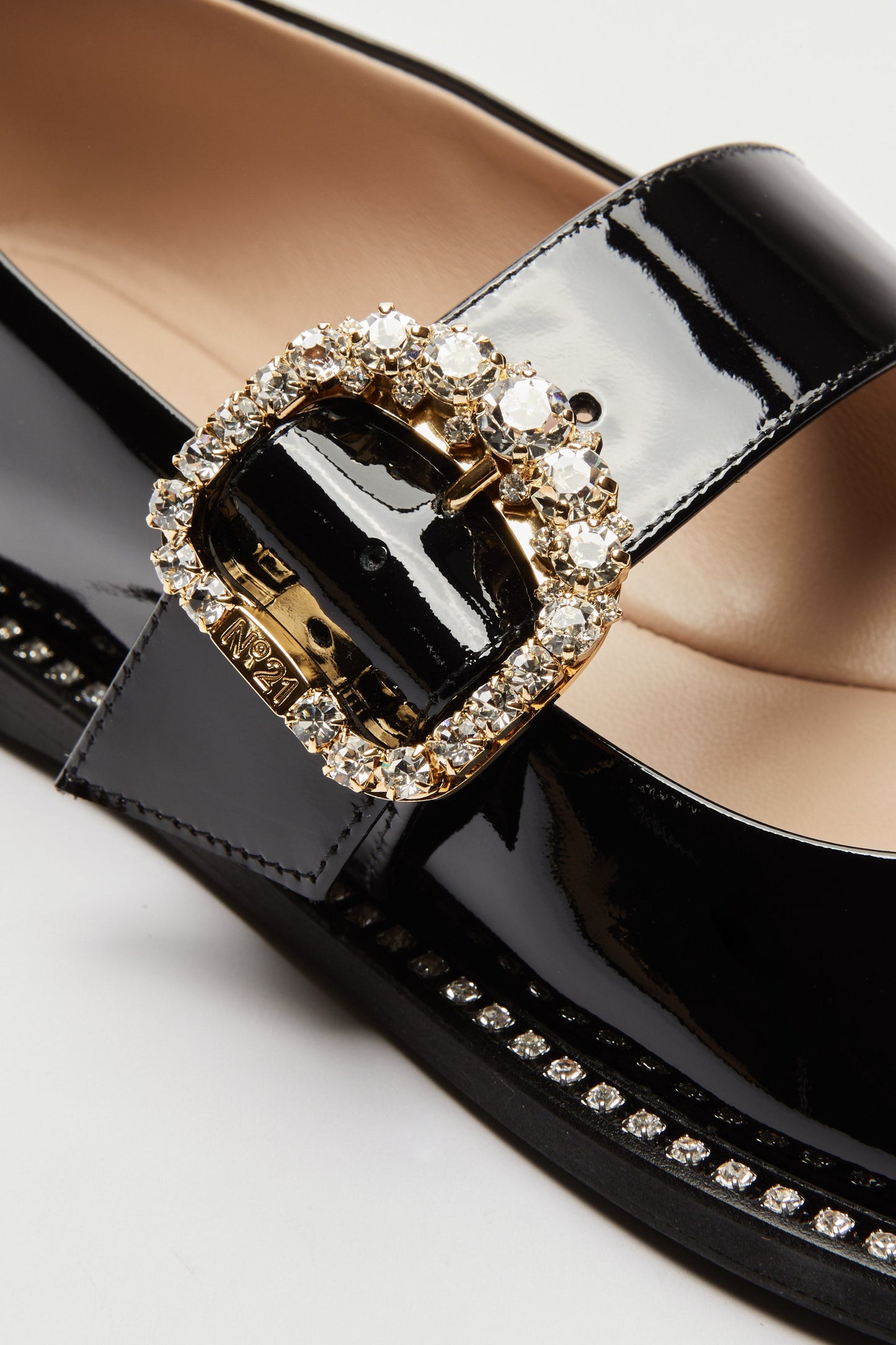 Women's brown leather loafers with gold buckle