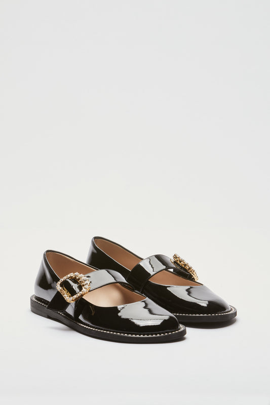 Women's brown leather loafers with gold buckle